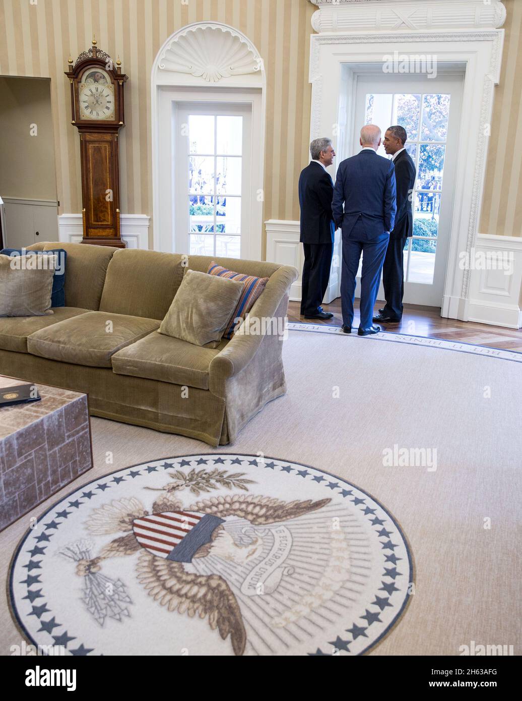 President Barack Obama and Vice President Joe Biden talk with Chief Judge Merrick B. Garland in the Oval Office, prior to a Rose Garden statement announcing Chief Judge Garland as the President's nominee to the United States Supreme Court, March 16, 2016. Stock Photo