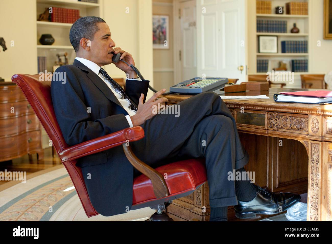 President Barack Obama talks on the phone with Haitian President René Préval in the Oval Office, Jan. 15, 2010. Stock Photo