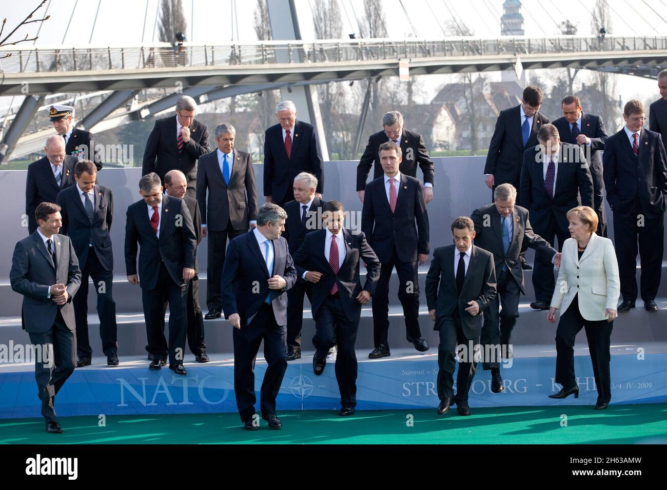 President Barack Obama, NATO Secretary General Jaap de Hoop Scheffer and fellow NATO leaders step down from a photo platform April 4, 2009, following their group photo at the NATO meeting in Strasbourg, France Stock Photo