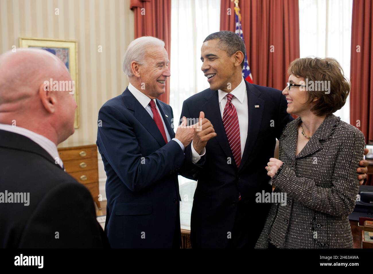 President Barack Obama and Vice President Joe Biden talk with former Representative Gabrielle Giffords and her husband, Mark Kelly, after the President signed H.R. 3801, the Ultralight Aircraft Smuggling Prevention Act of 2012, in the Oval Office, Feb. 10, 2012. The bill was the last piece of legislation that Giffords sponsored and voted on in the U.S. House of Representatives Stock Photo