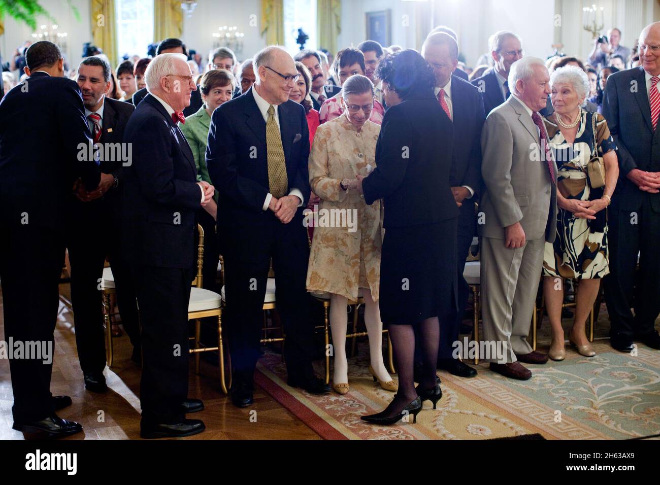 Supreme Court Justice Sonia Sotomayor stops to greet Justice Ruth Bader Ginsburg at the conclusion of a reception in the East Room of the White House, August 12, 2009. Stock Photo