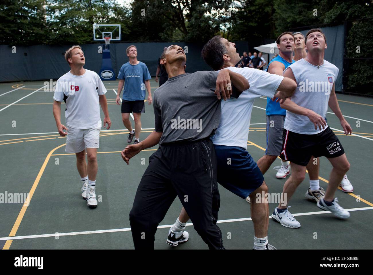 President Barack Obama, along with Cabinet Secretaries and Members of Congress, watch a shot during a basketball game on the White House court, Oct. 8, 2009 Stock Photo