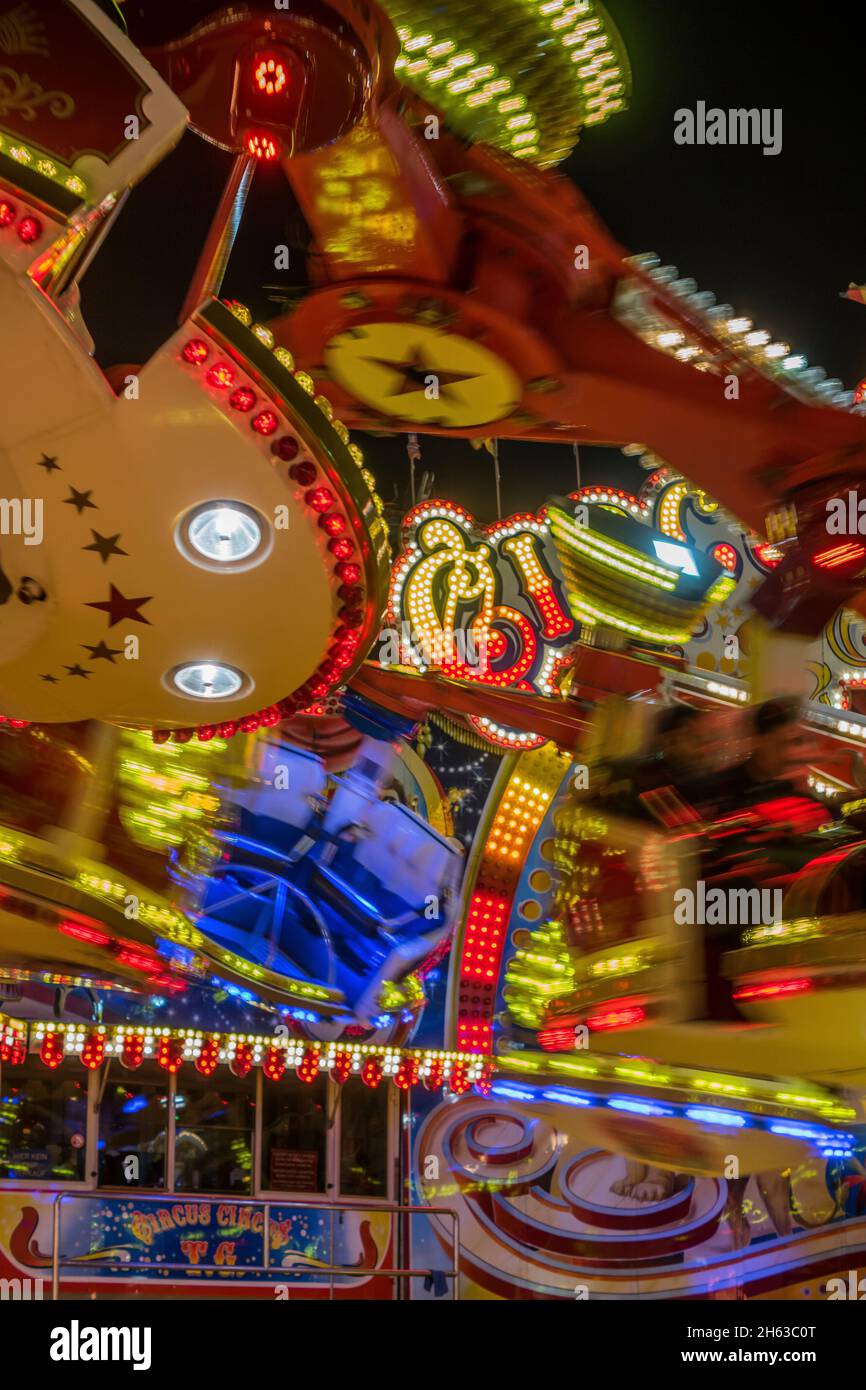 fairground rides and carousels in motion on the cathedral in hamburg,germany. Stock Photo