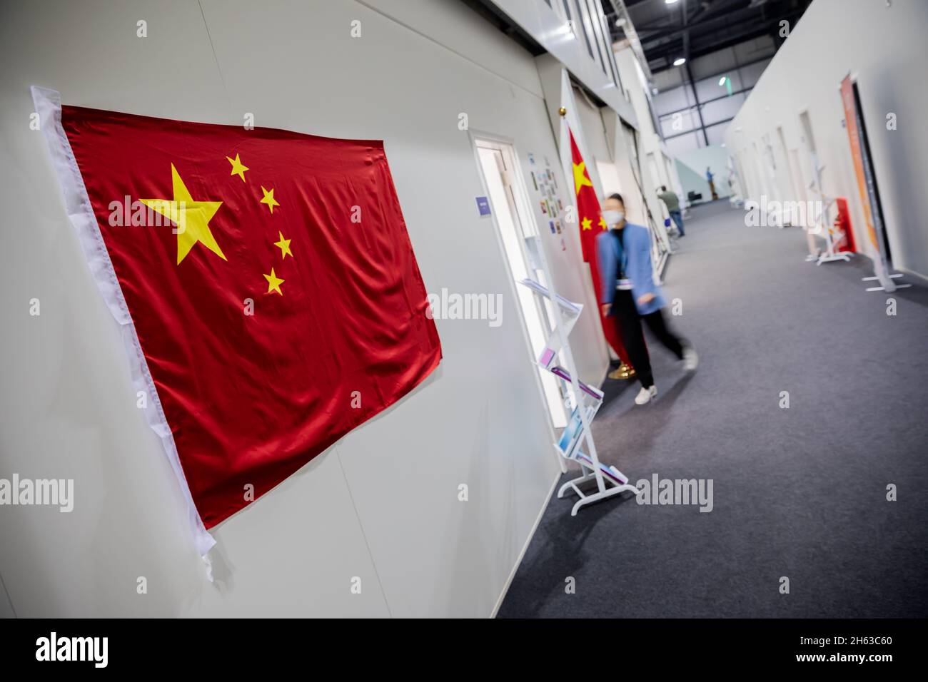 Glasgow, UK. 12th Nov, 2021. A woman walks into the Chinese delegation office at the UN Climate
