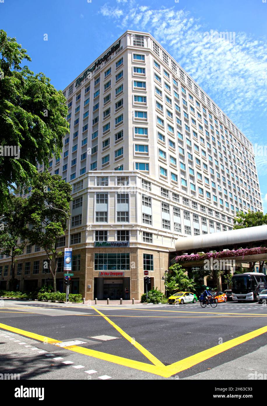 A view looking up at Raffles Hospital in theBugis area of Singapore at the intersection of Ophir Road and North Bridge Road. Stock Photo