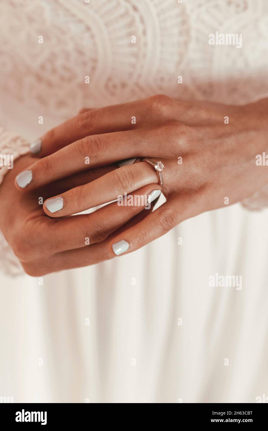 bride puts engagement ring on her finger Stock Photo Alamy