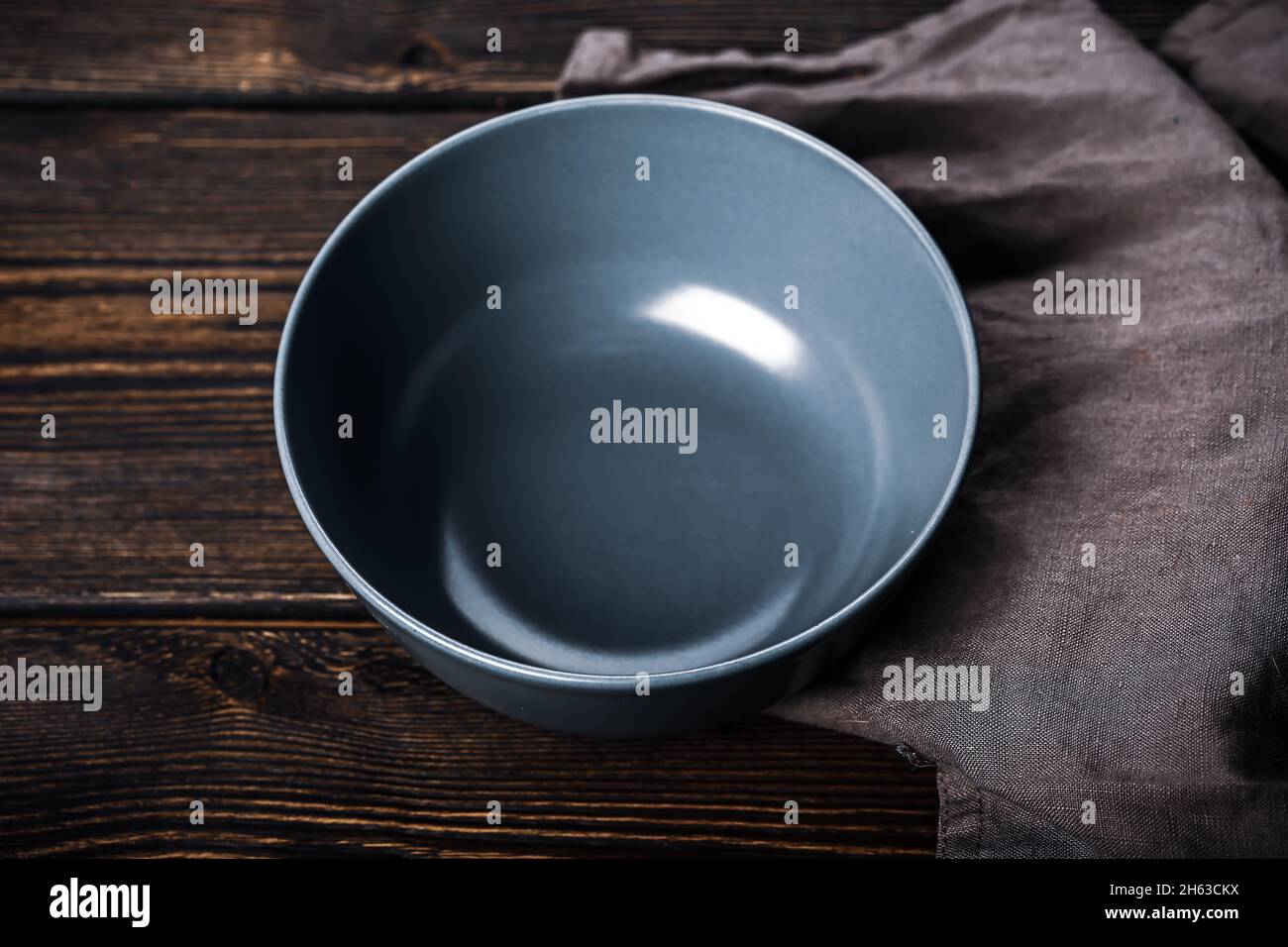 Empty gray plate on a wooden background. Kitchen mockup Stock Photo