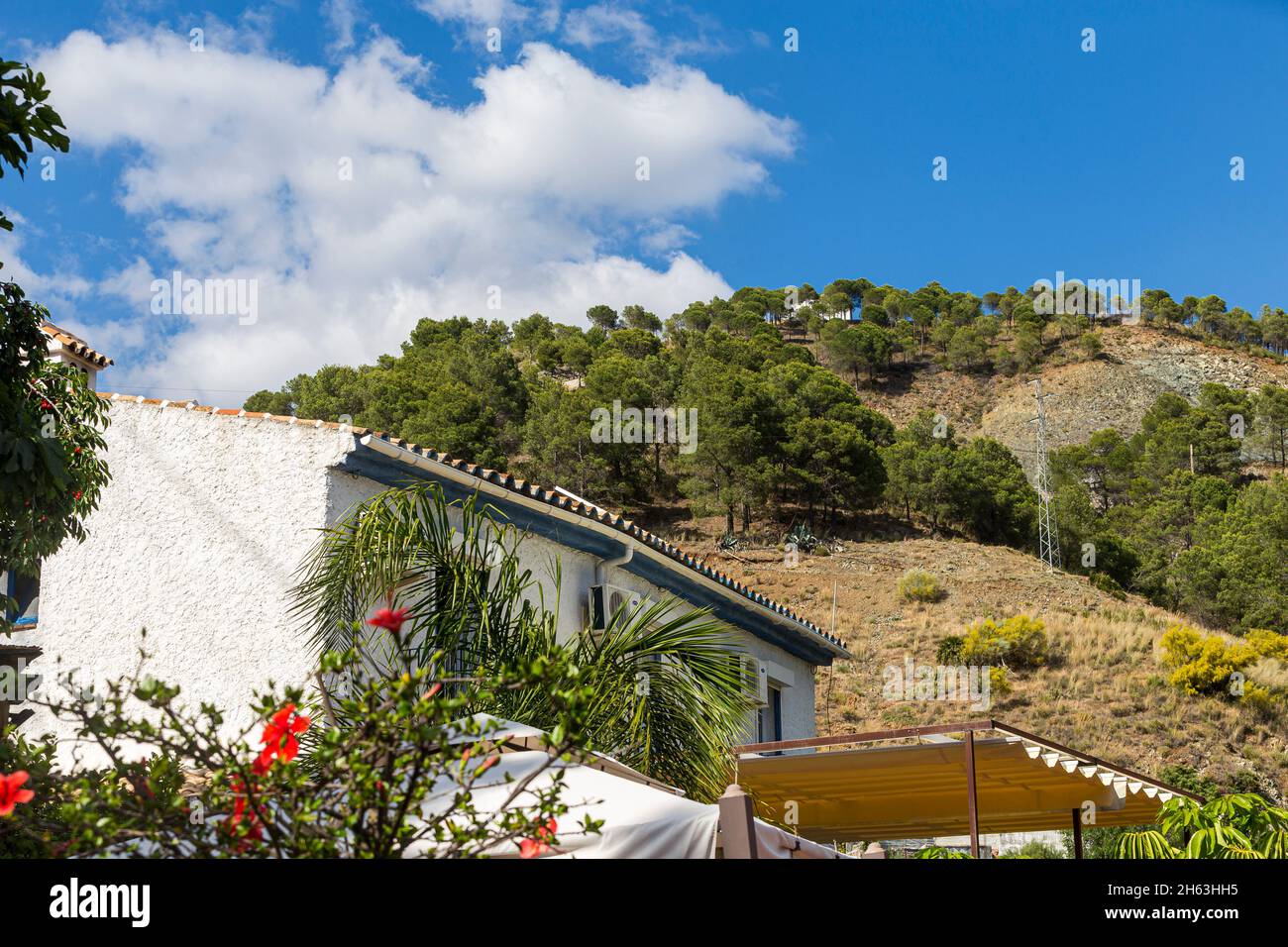 a house on the hills and big clouds up above in andalusia,spain Stock Photo