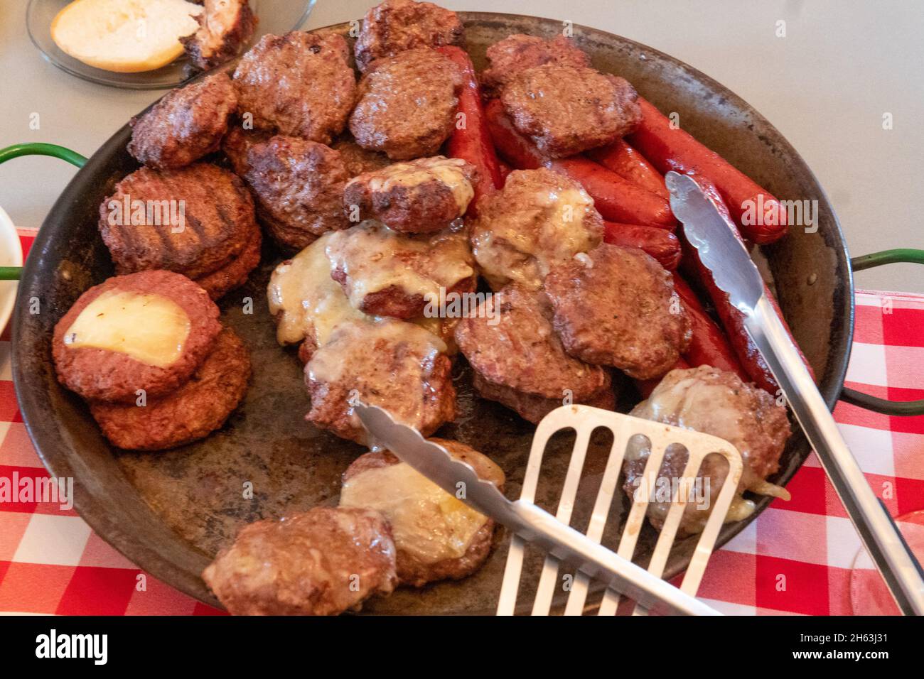 BBQ beef patties and hotdogs on skillet Stock Photo Alamy