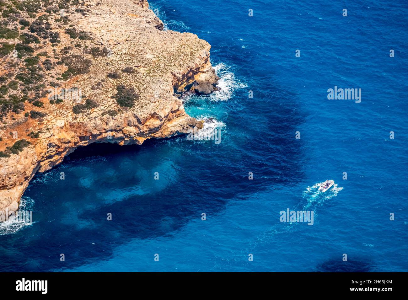 aerial view,rocky coast and motorboat in front of manacor,balearic islands,mallorca,spain Stock Photo