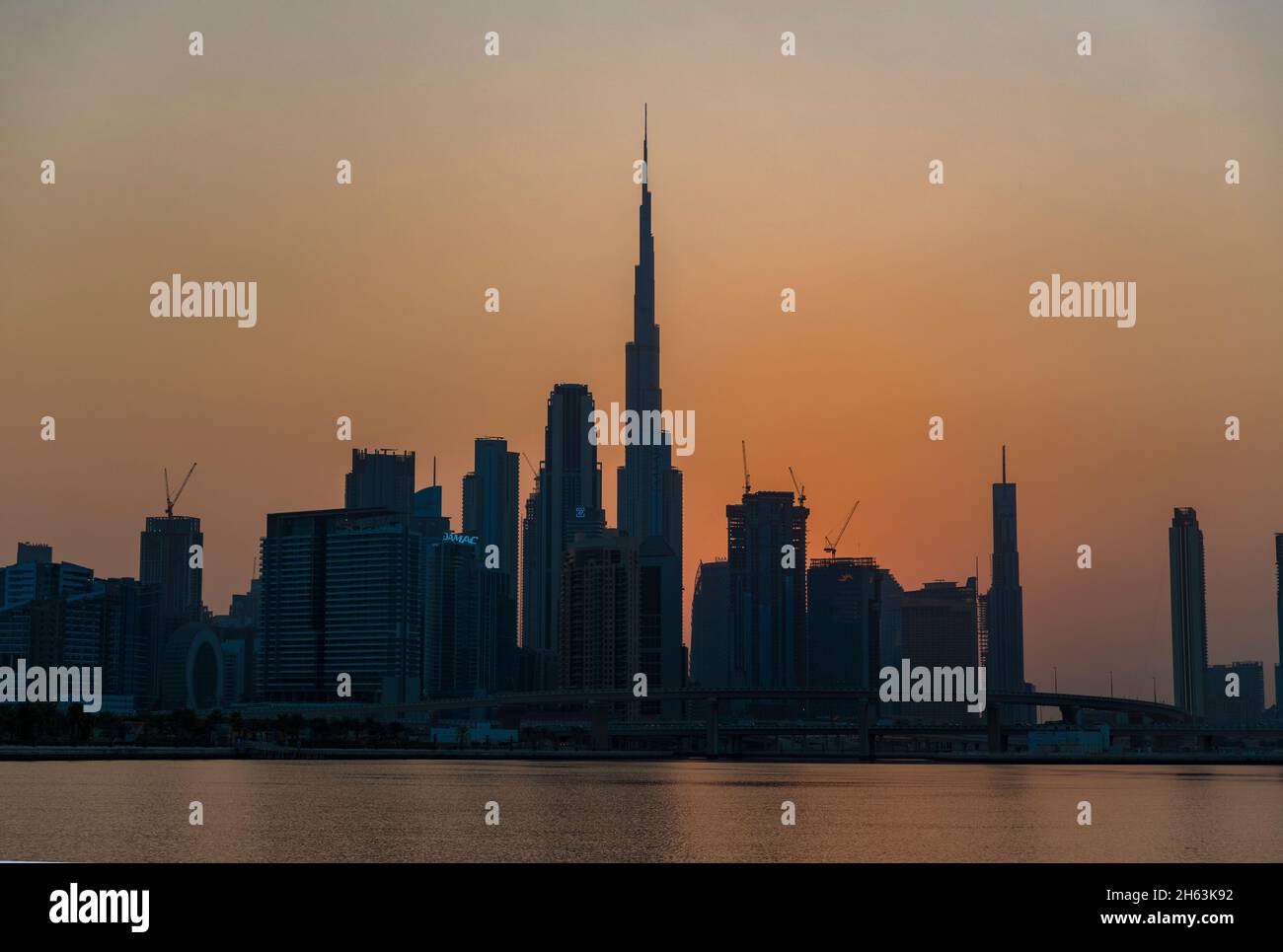 Burj Khalifa and skyscrapers at dusk Dubai Creek UAE Stock Photo