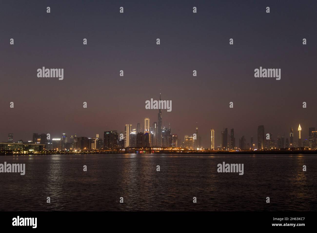 Panoramic view Burj Khalifa and city skyline at twilight Dubai Creek UAE Stock Photo