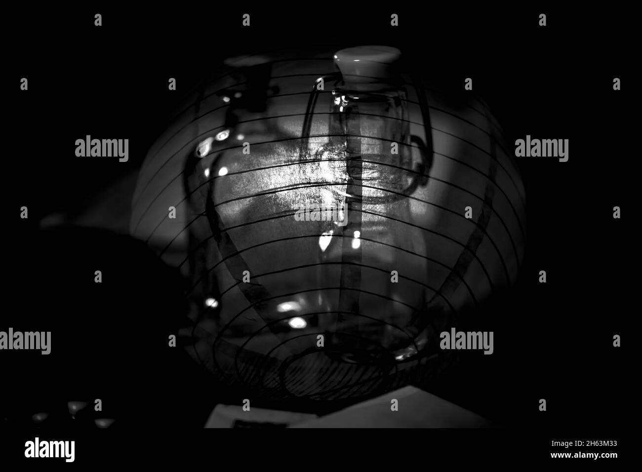 abstract unique multiple exposure,ceiling lamp and glass bottles,black and white Stock Photo