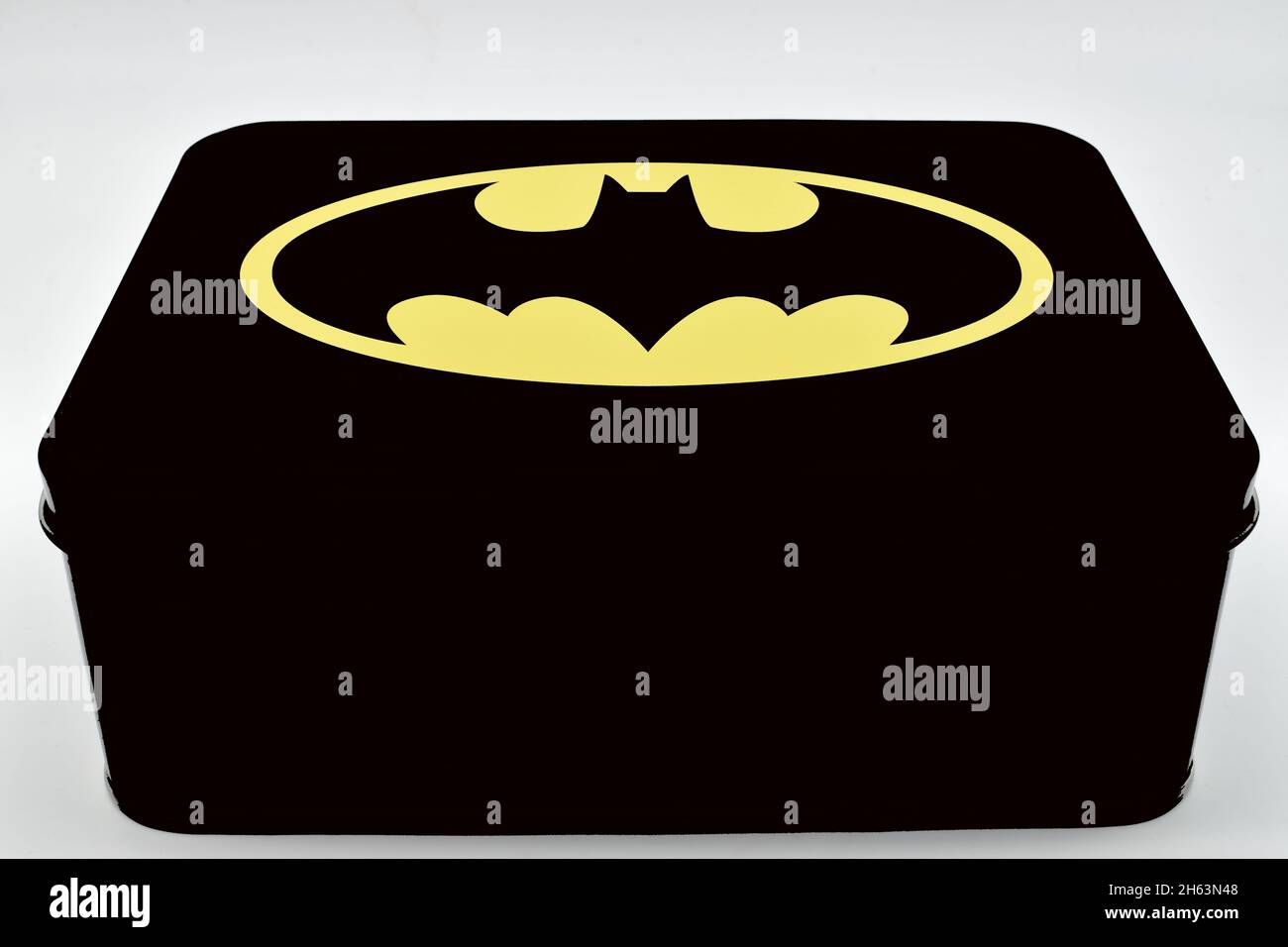 Batman black tin box with classic logo isolated on white background. Stock Photo
