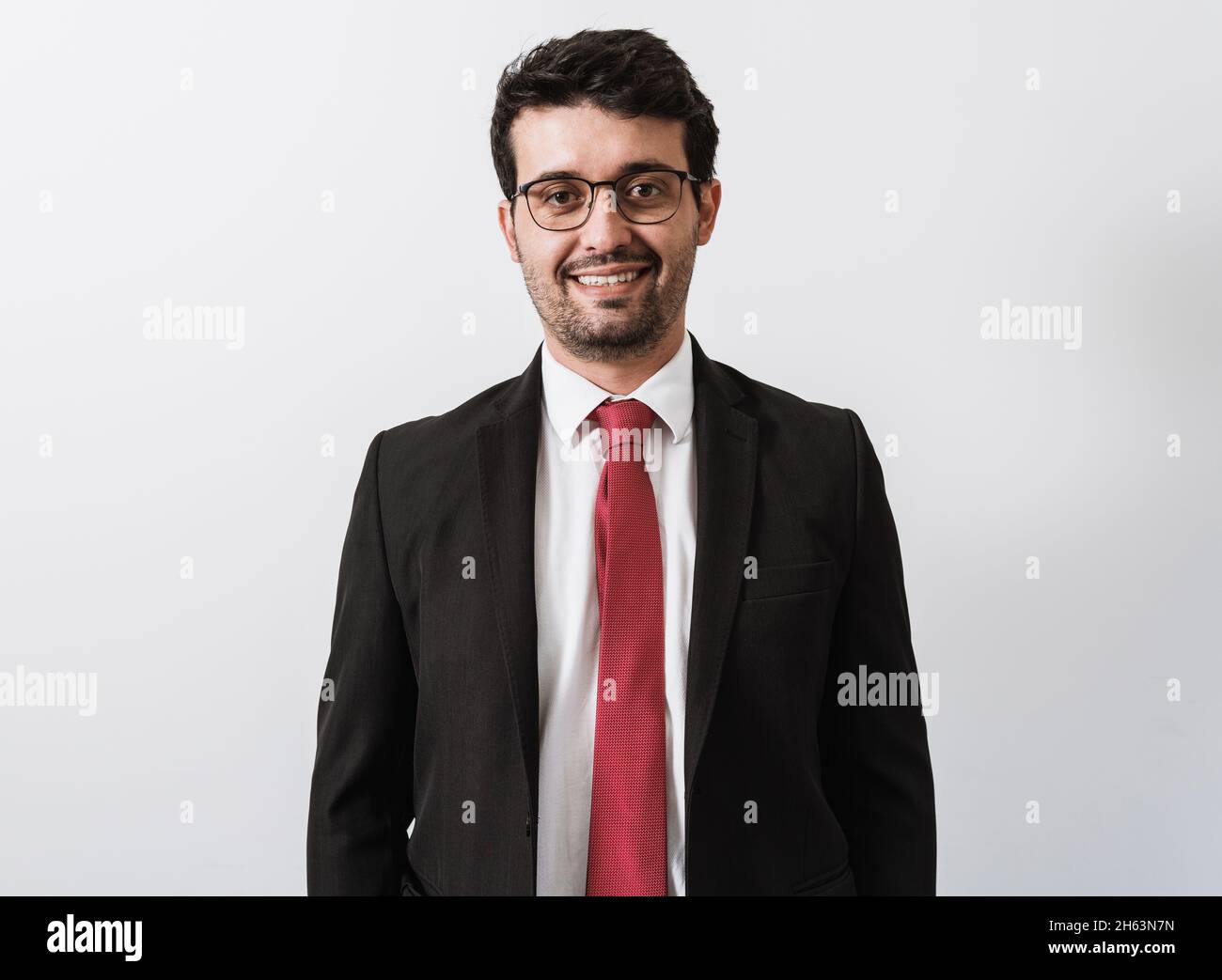 Young Latino businessman or lawyer on white background Stock Photo - Alamy