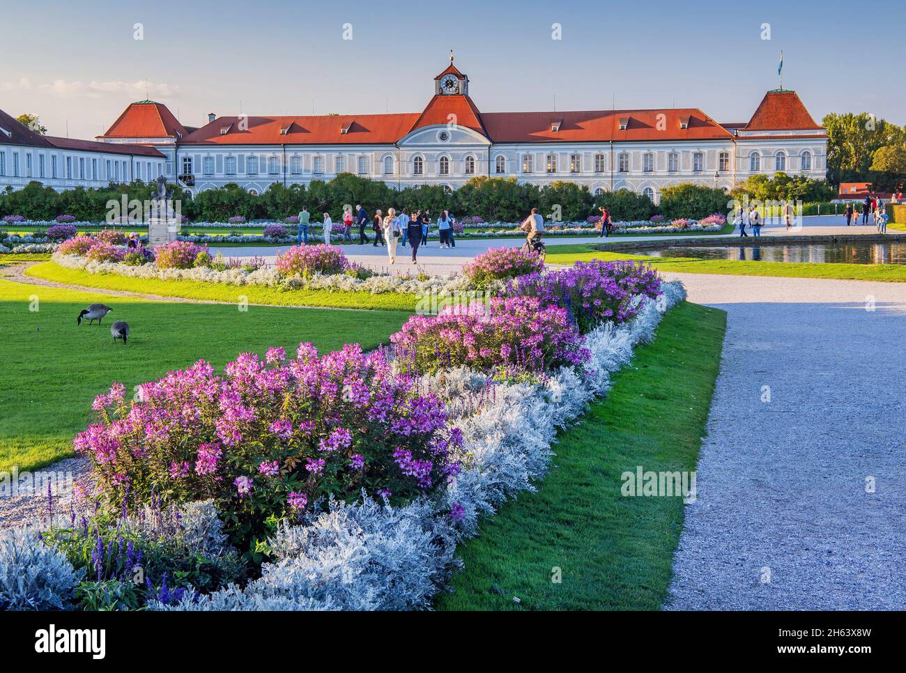 flower borders in front of the north wing of nymphenburg palace at evening sun,munich,upper bavaria,bavaria,germany Stock Photo