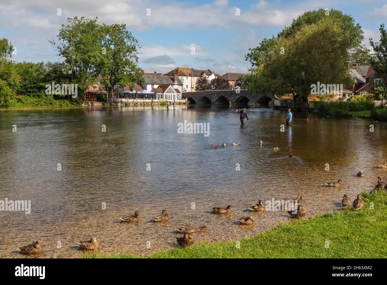 england,hampshire,the new forest,fordingbridge,town view and fly fisherman in the river avon Stock Photo