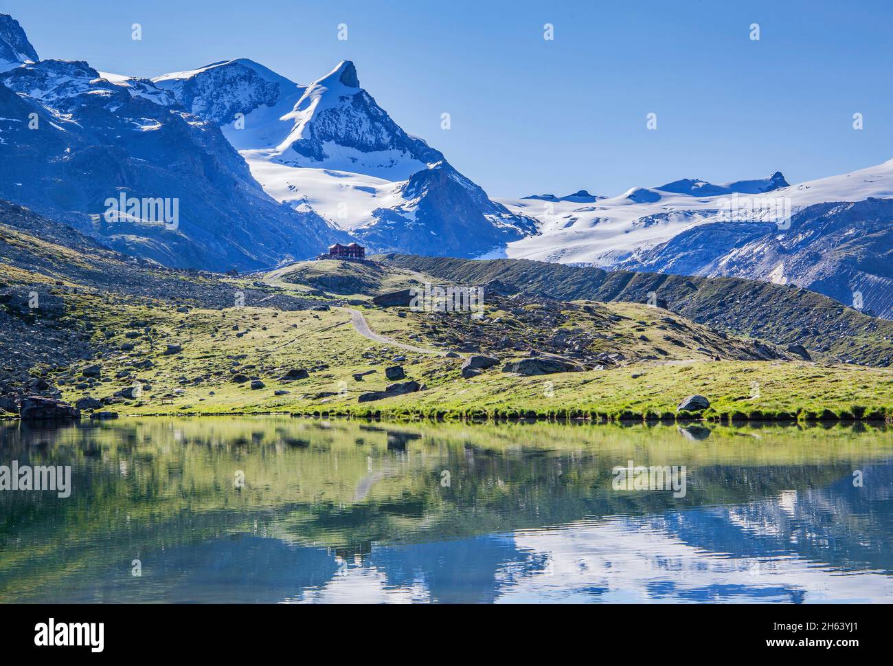 stellisee with berghaus fluhalp against strahlhorn 4190m and adlerhorn 3988m,zermatt,mattertal,valais alps,valais,switzerland Stock Photo