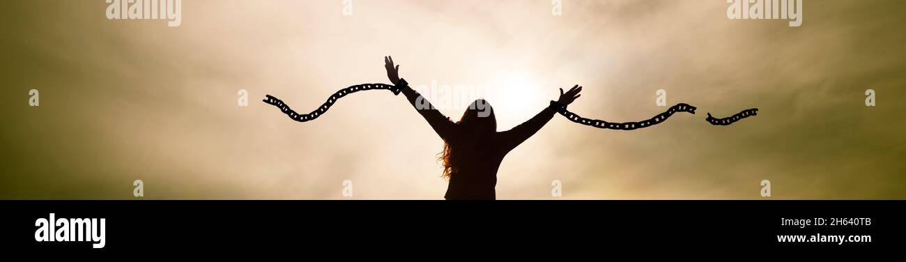 woman breaks her chains as a symbol of freedom Stock Photo