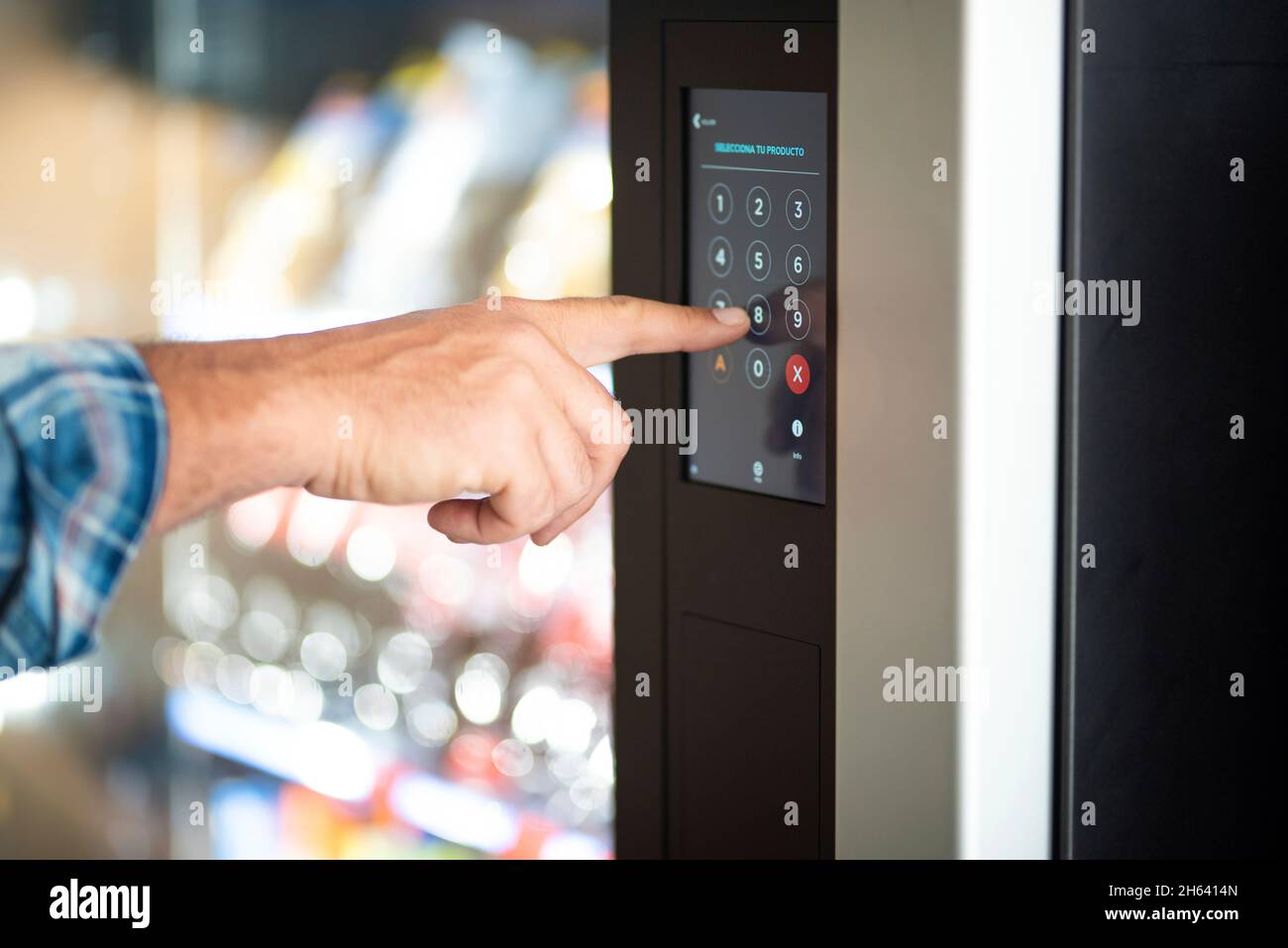 close up of man hand typing number code on touch screen display - concept of security password and automatic distributor food - caucasian male finger type 8 Stock Photo