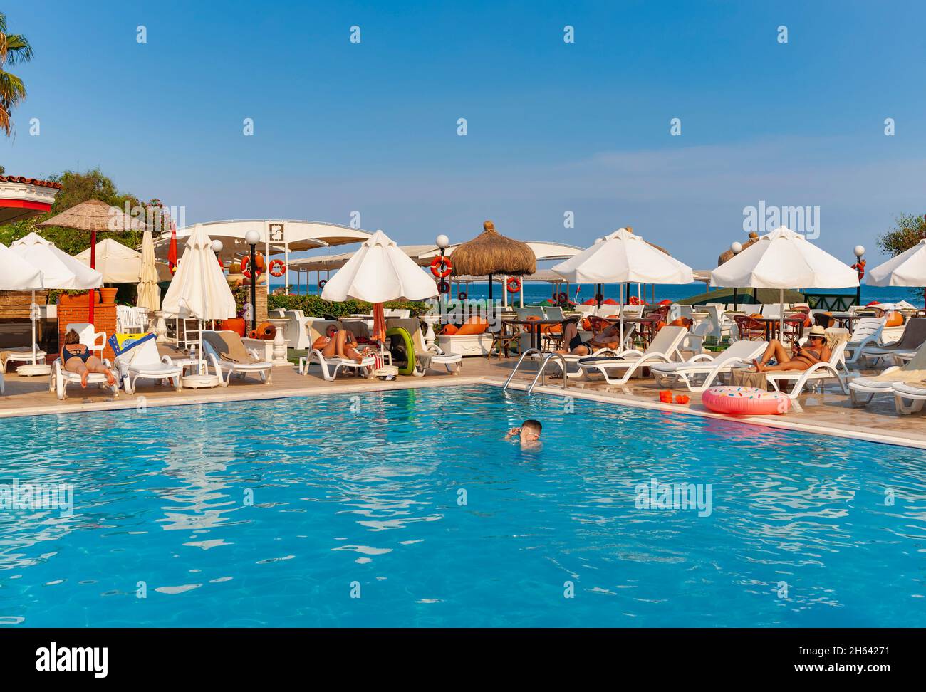 hotel pool and guests on lara beach,antalya,turkey Stock Photo