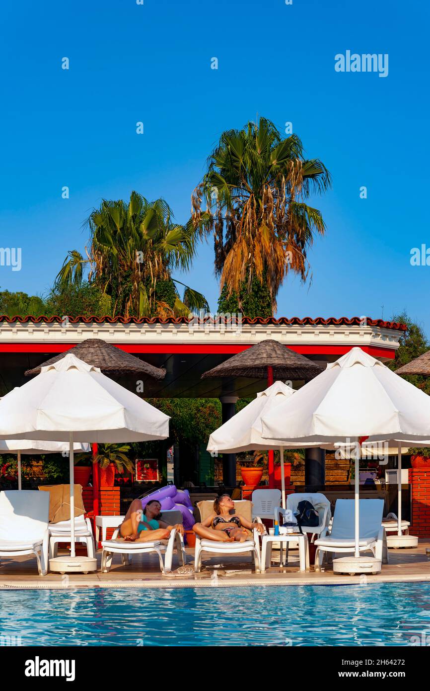 hotel pool and palm trees on lara beach,antalya,turkey Stock Photo
