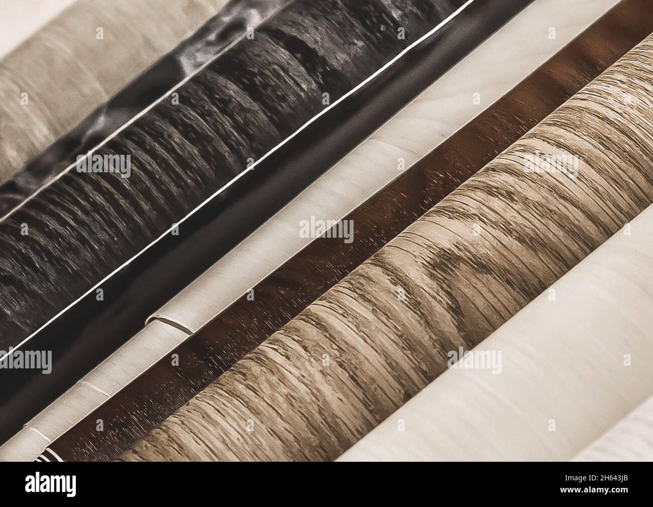 Assortment of light and dark wallpaper in rolls with an abstract pattern in a hardware store. Stock Photo