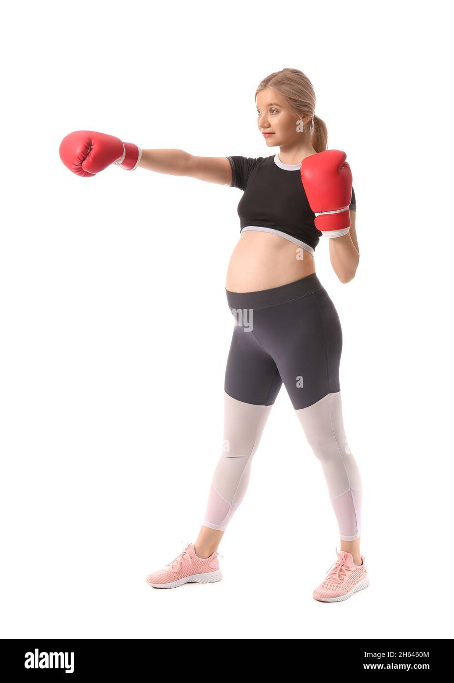 Young pregnant woman in boxing gloves on white background Stock Photo