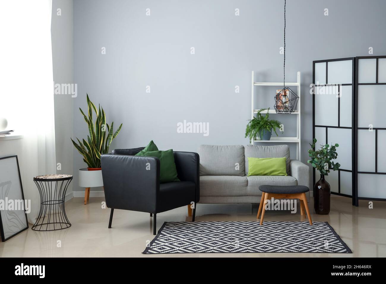 Interior of modern living room with armchair, sofa and houseplants ...