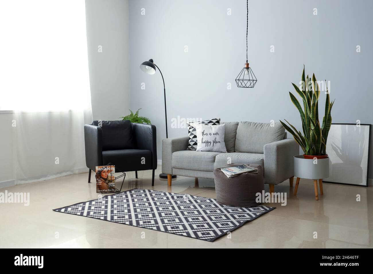 Interior of stylish living room with modern armchair and sofa Stock ...