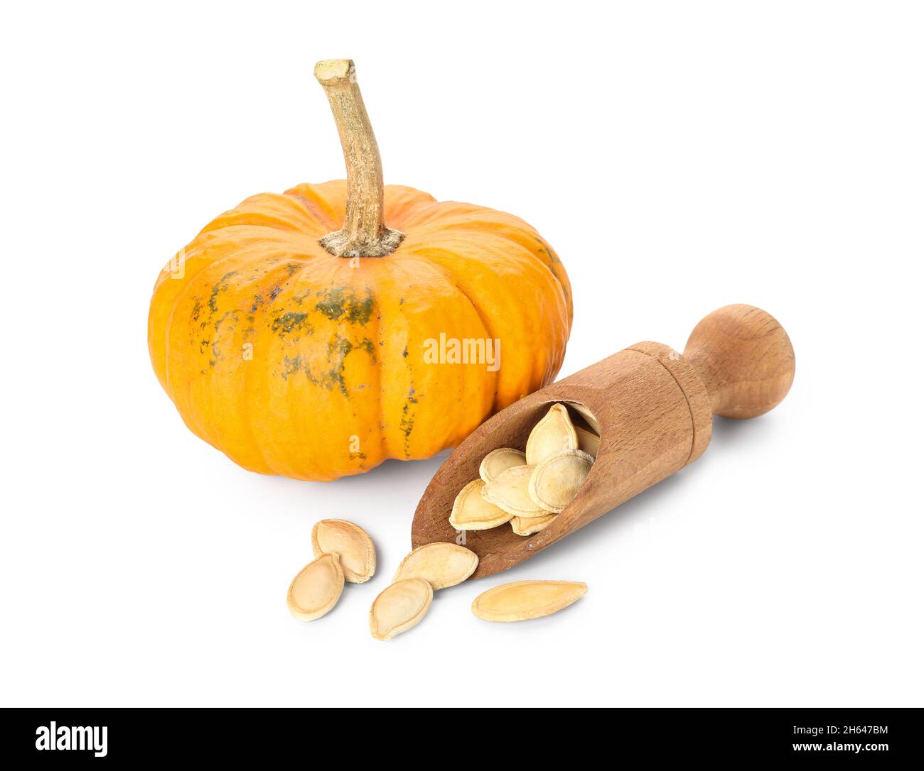 Scoop with pumpkin seeds on white background Stock Photo