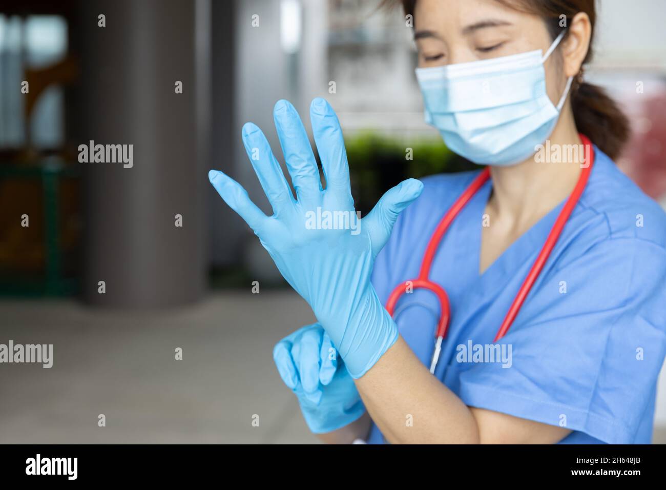 Medical staff wearing gloves to prepare for the outbreak of communicable diseases Corona Virus (COVID-19) Stock Photo