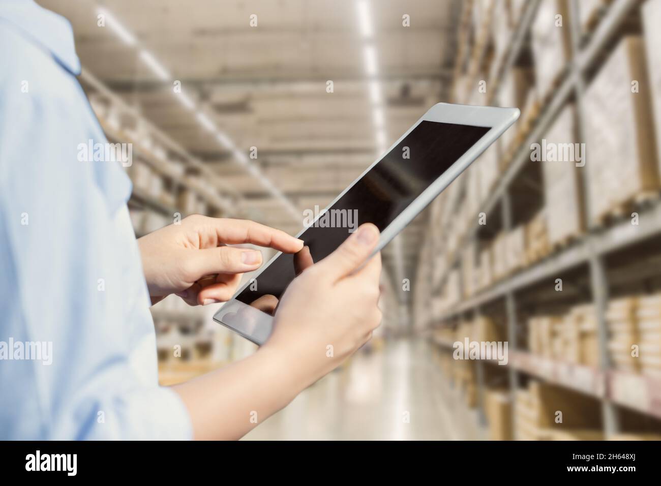 Staff using tablet with smart warehouse tracking inventory management
