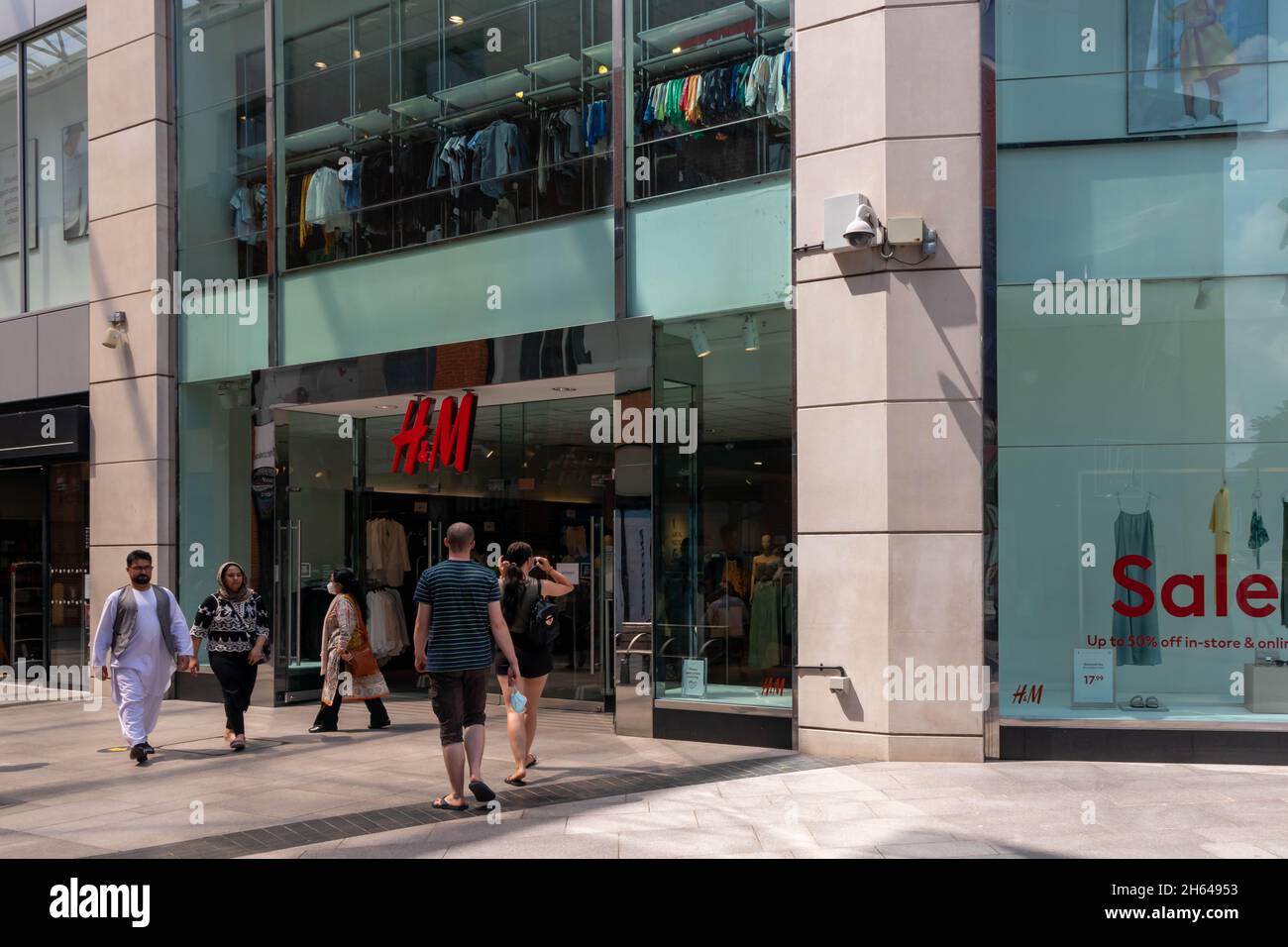High Wycombe, England - July 21st 2021: People entering and leaving a H& M store.. The chain is owned by a Swedish mutinational Stock Photo