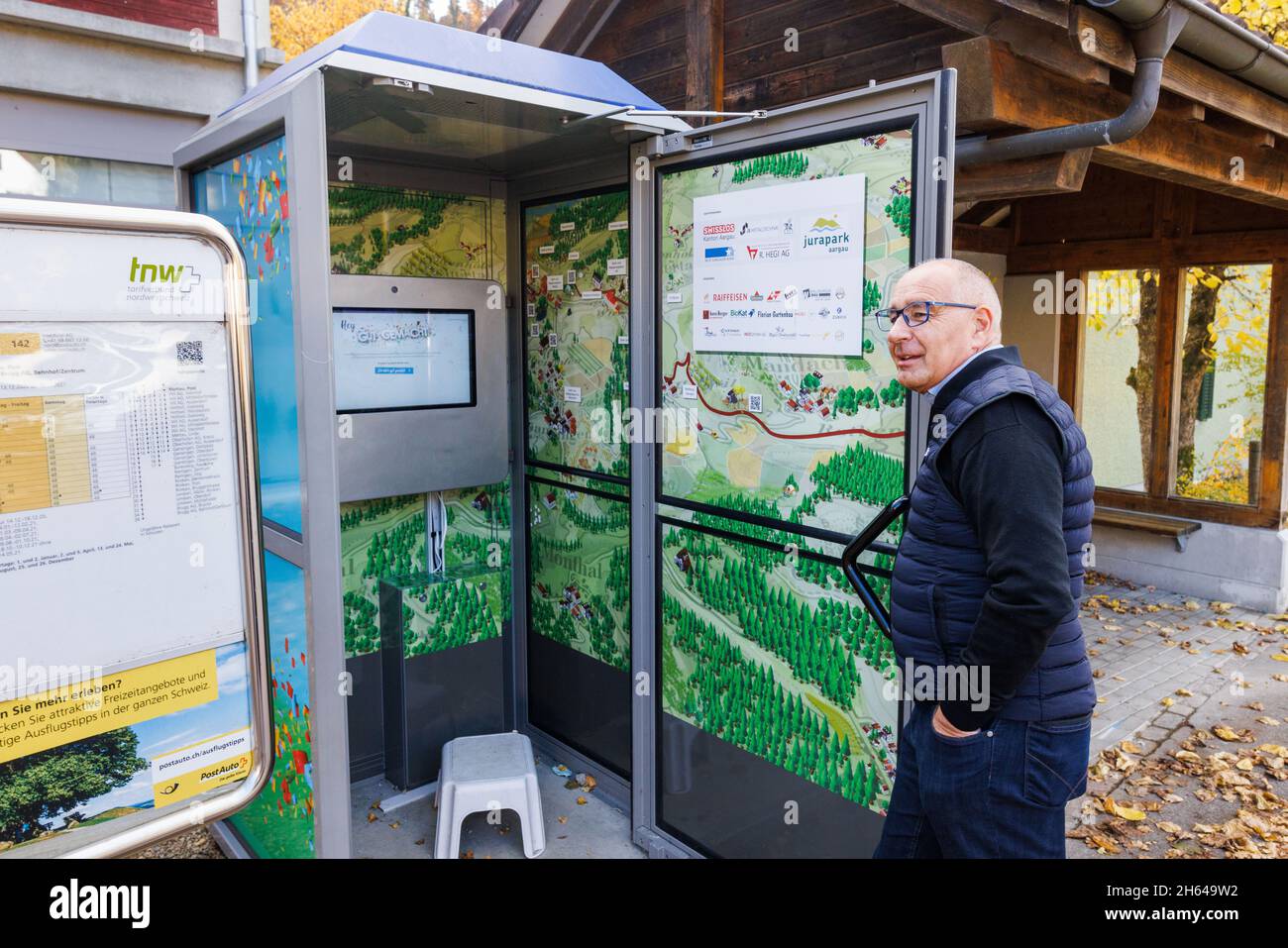Mettauertal, Switzerland. 08th Nov, 2021. Peter Weber (no party  affiliation), mayor of Mettauertal, stands in front of the telephone box  that has been converted into a "shoulder tapping machine". Anyone who thinks