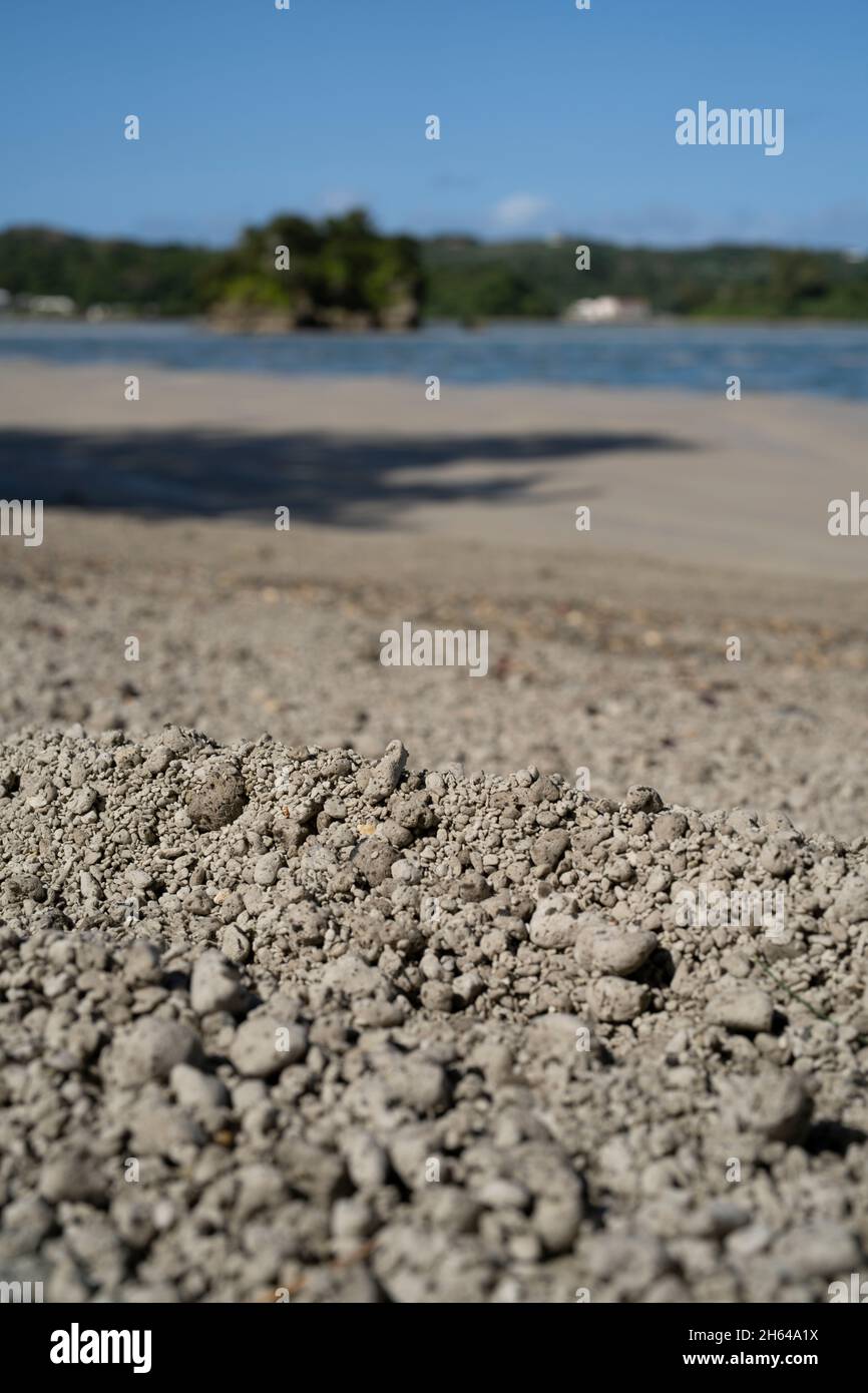 Nakijin, Okinawa, Japan. Beaches covered with pumice stones after undersea volcanic eruption near the Ogasawara Islands. Pumice floating on the surface of the ocean. Stock Photo