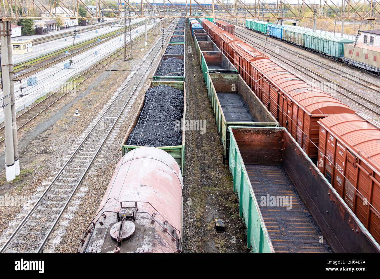 Freight train open cars loaded with coal cargo, stationary in a depot on rails. Karaganda, Kazakhstan, Central Asia Stock Photo