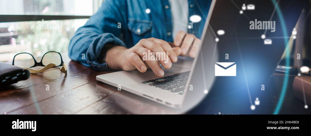 Close-up photo of male hands with laptop. Man working remotely at home. Concept of networking or remote work. Global business network. Stock Photo