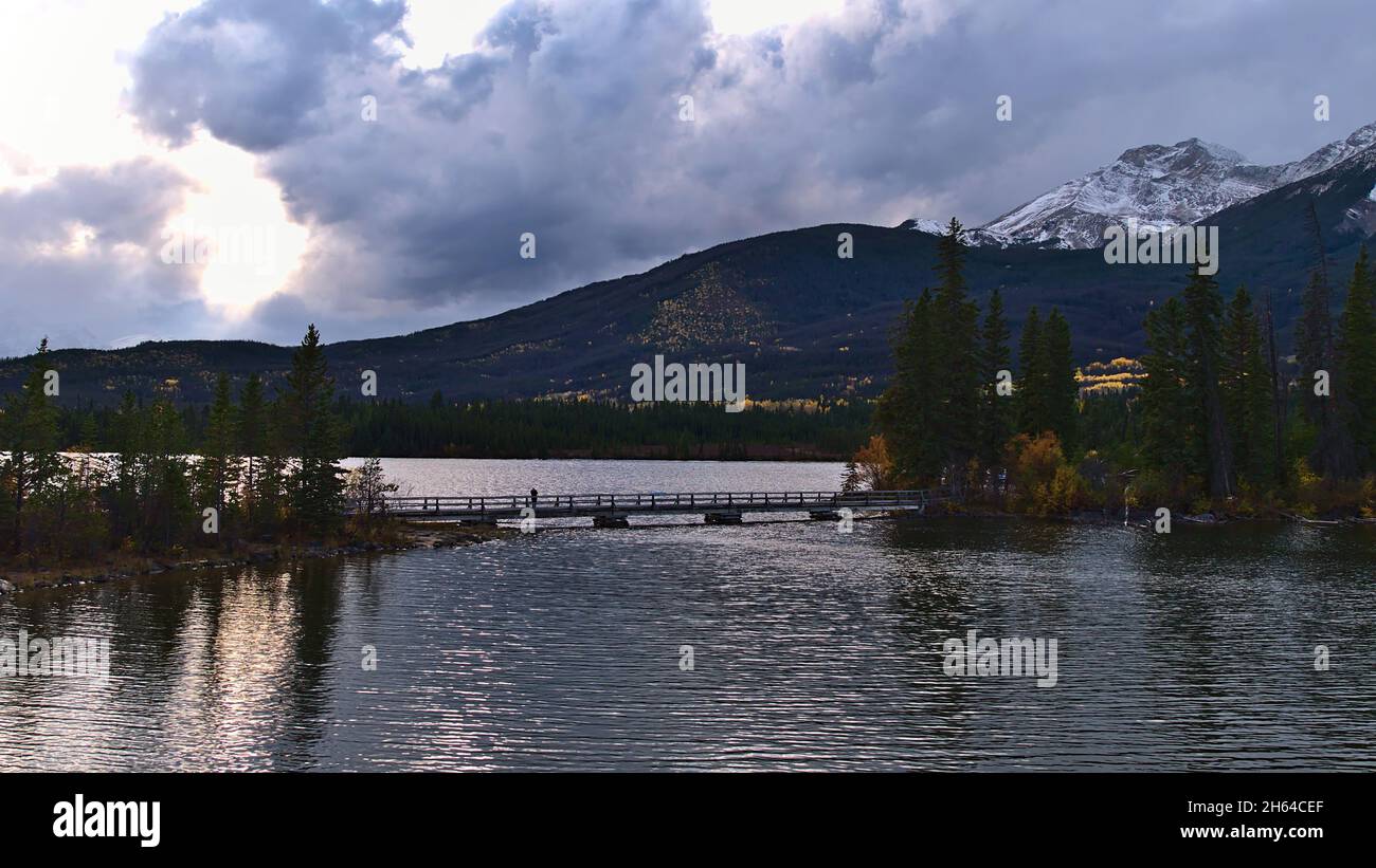 Beautiful view of Pyramid Lake in the evening sun in Jasper National Park, Alberta, Canada in the Rocky Mountains with bridge and island. Stock Photo