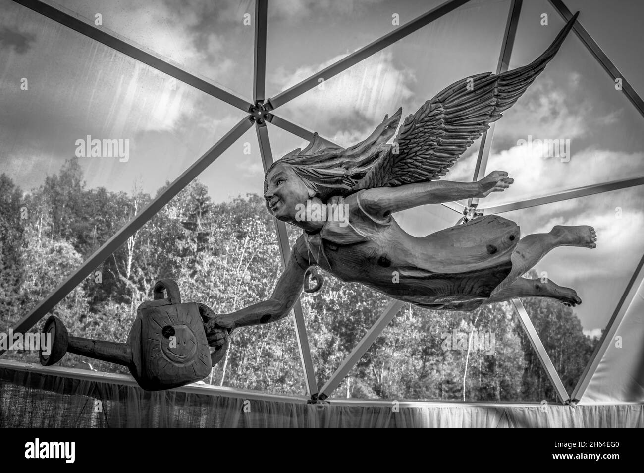 Wooden sculpture of a flying angel in Ruskeala Mountain Park. Karelia, Russia. Black and white. Stock Photo