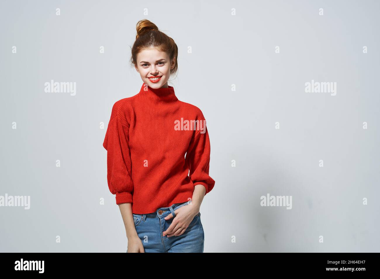pretty woman in a red sweater isolated background Stock Photo - Alamy