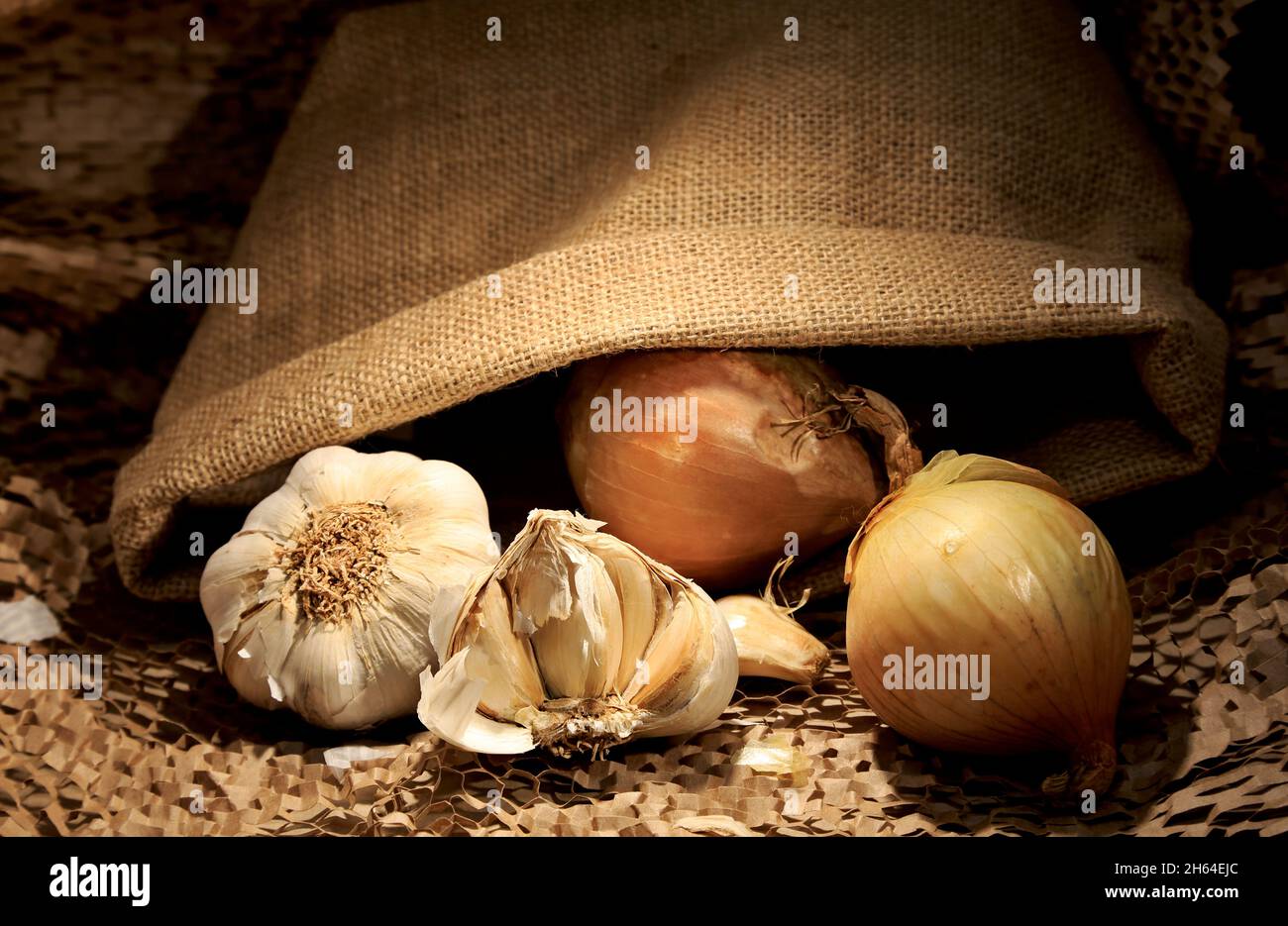 Onion and garlic with jute bag Stock Photo