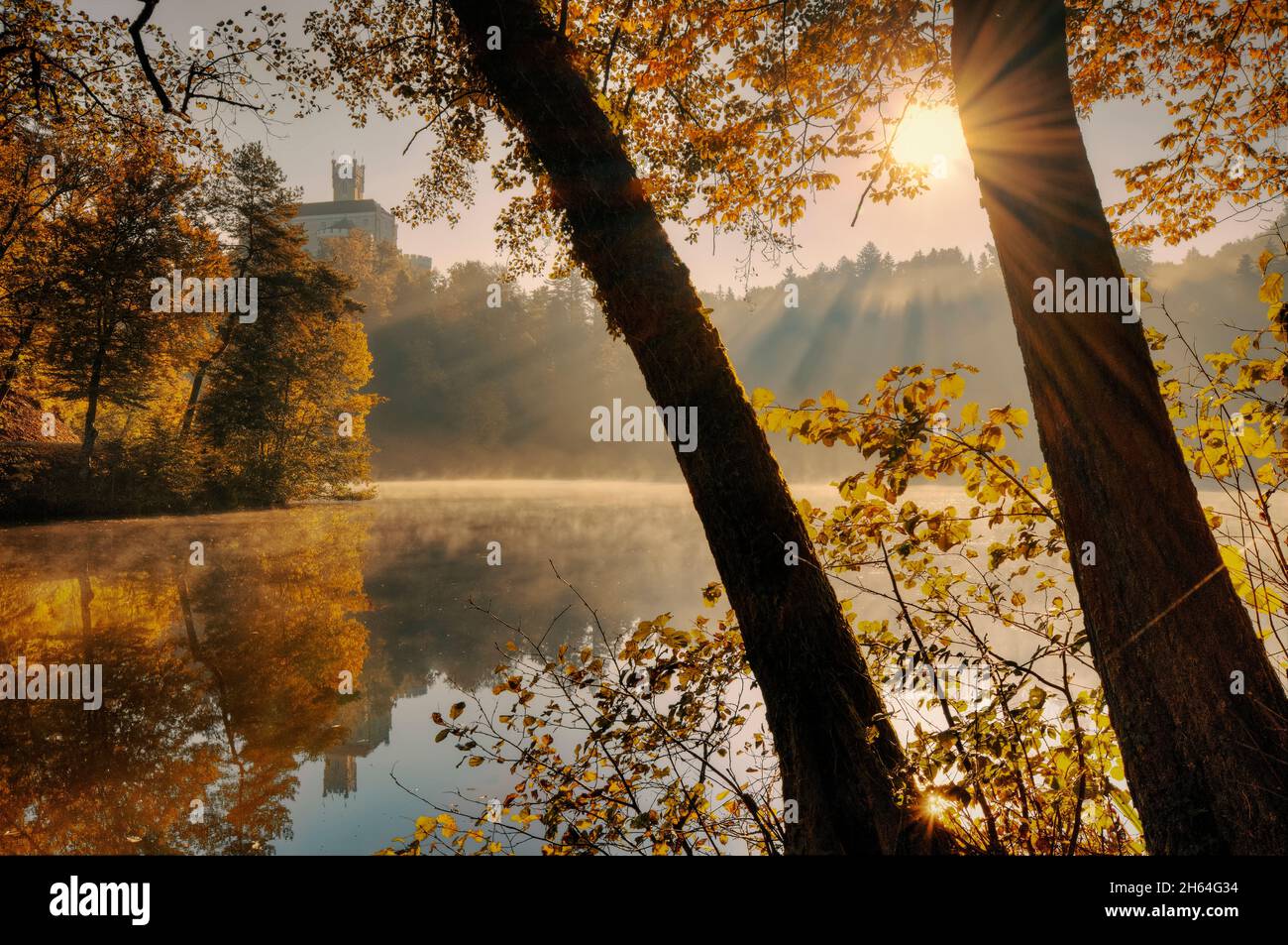 Beautiful autumn sunrise scenery of Trakošćan Castle on the hill by reflected in Lake in Croatia, county hrvatsko zagorje Stock Photo