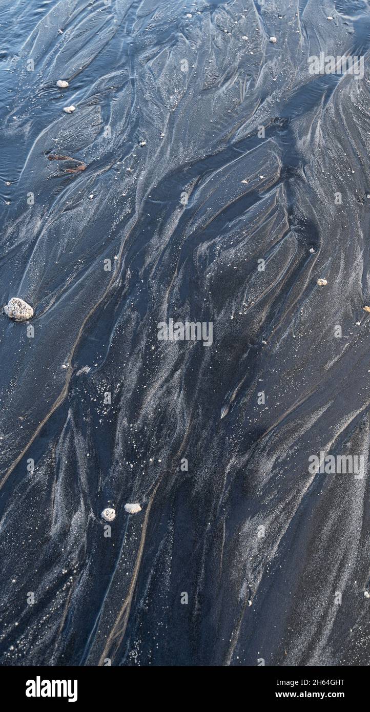 Black texture of beach seashore sand dunes,flat lay,The sea of Okhotsk. Stock Photo