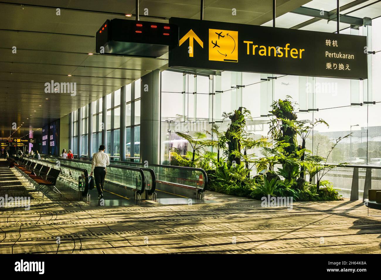 Travellers arriving and transferring to another aircraft in Changi Airport,Terminal 3, Singapore. Stock Photo