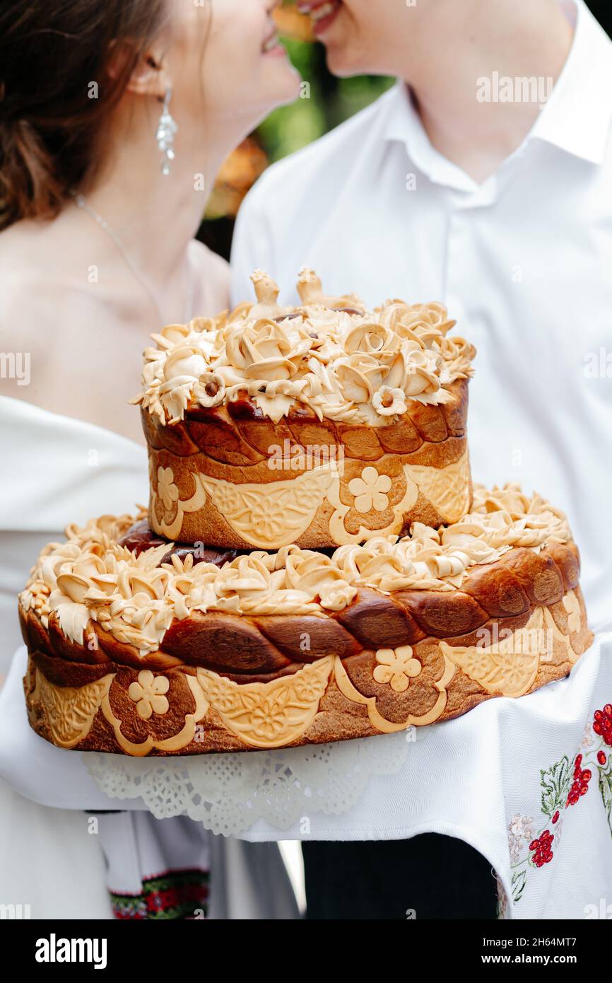 Charming wedding couple holding their wedding cake close up Stock Photo