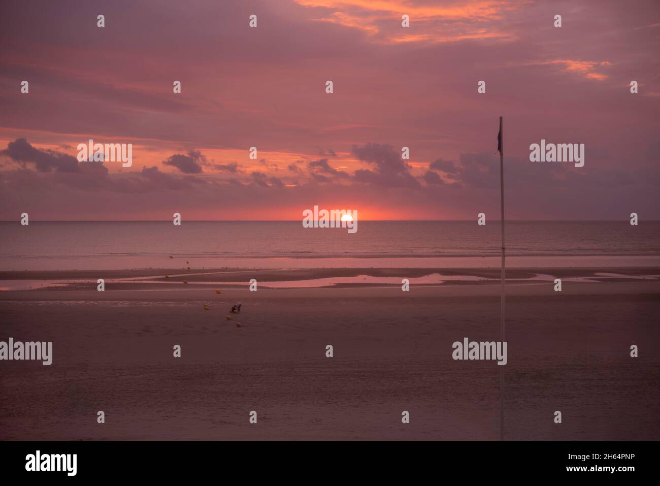 Sunset on a beach by the sea Stock Photo - Alamy