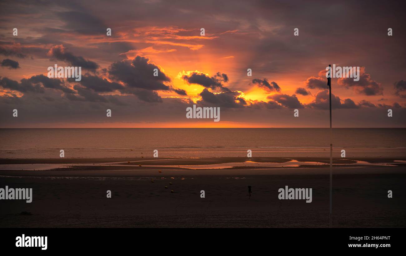 Sunset on a beach by the sea Stock Photo - Alamy