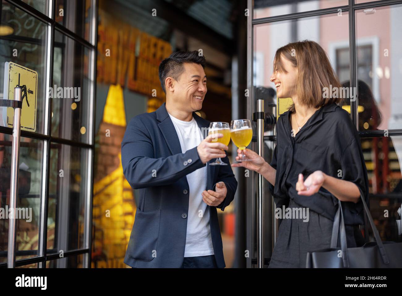 Woman and man drinking cocktails at cafe Stock Photo