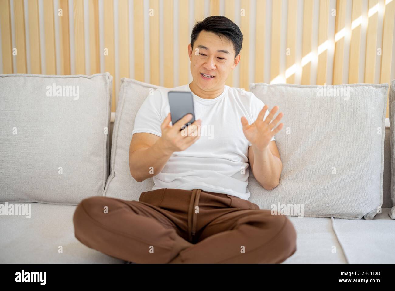 Asian man having video call on smartphone Stock Photo